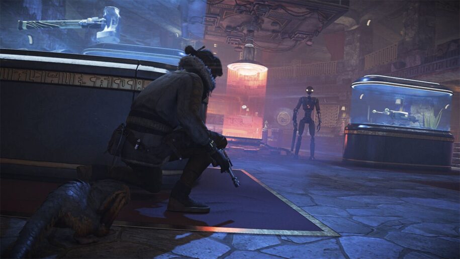 Star Wars Outlaws game screenshot. Character crouched in behind glass museum display, blaster in hand. A droid stands straight ahead, with yellow glowing eyes.